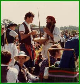 Arthur Knowles & Dave Nichols share some sword cake, Midwest Morris Ale, 1983